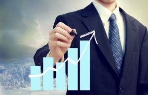 Business Man with Chart Showing Growth
